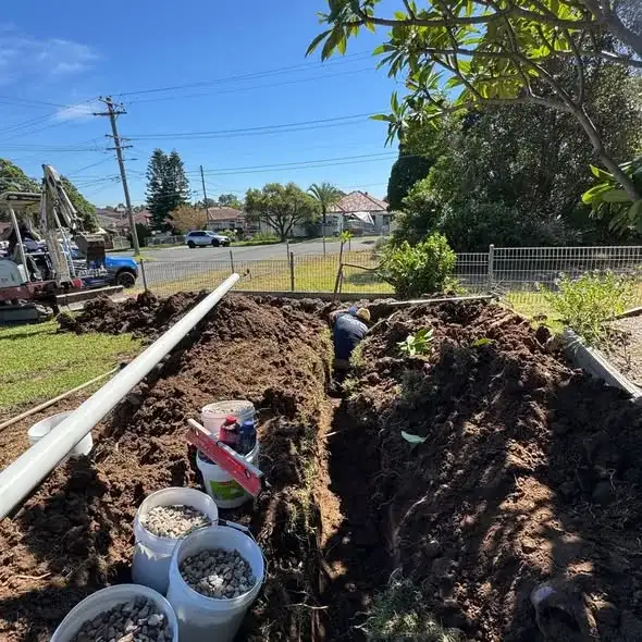 Exposed drainage pipework in an open trench